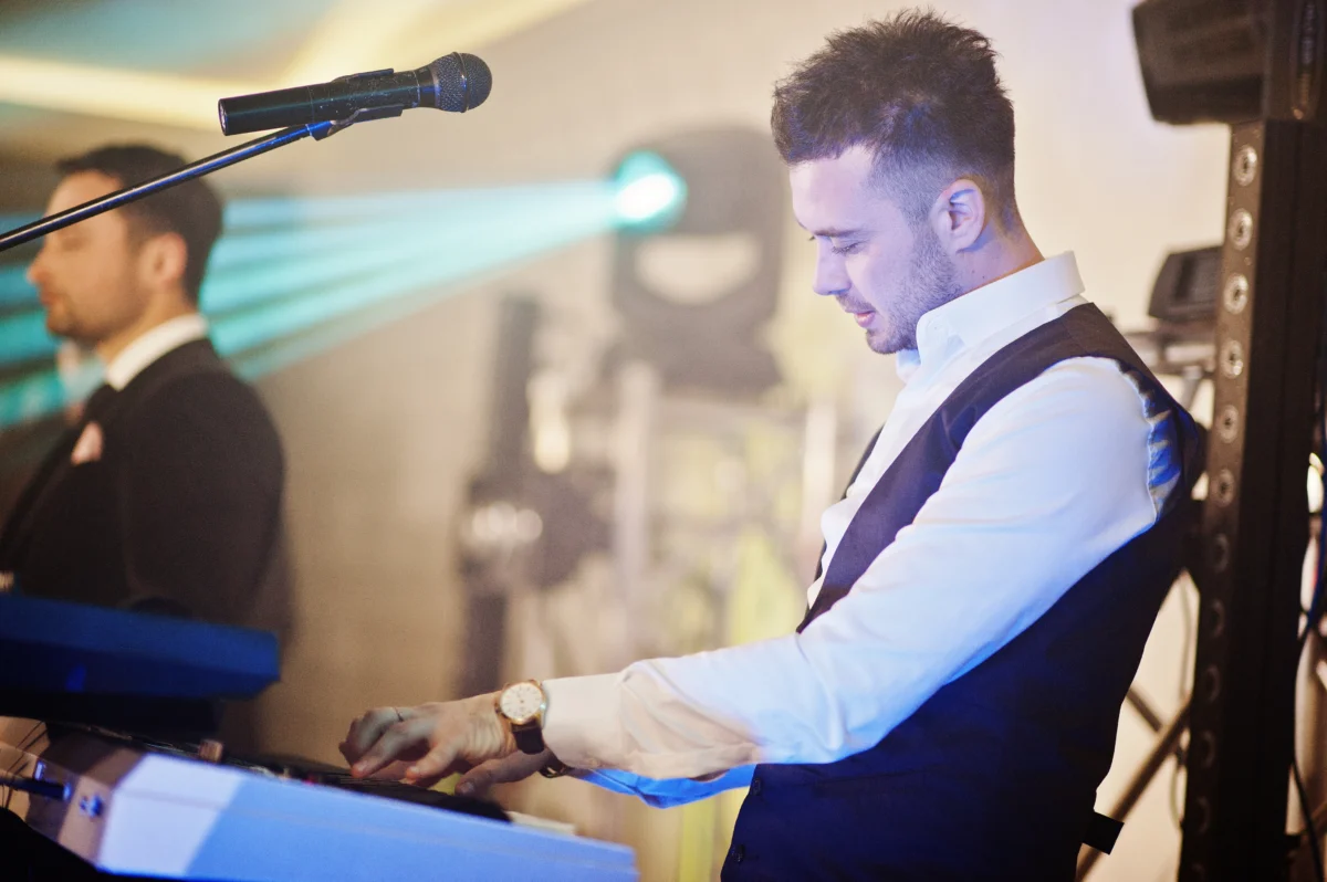 Performer playing on the keyboard at wedding next to DJ - Live Music Edmonton - Talent Productions
